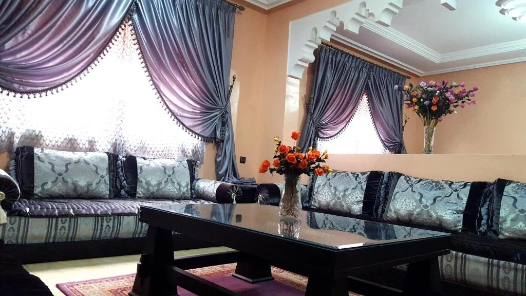 Elegant lounge with decorative curtains at Villa Annakhil Marrakech